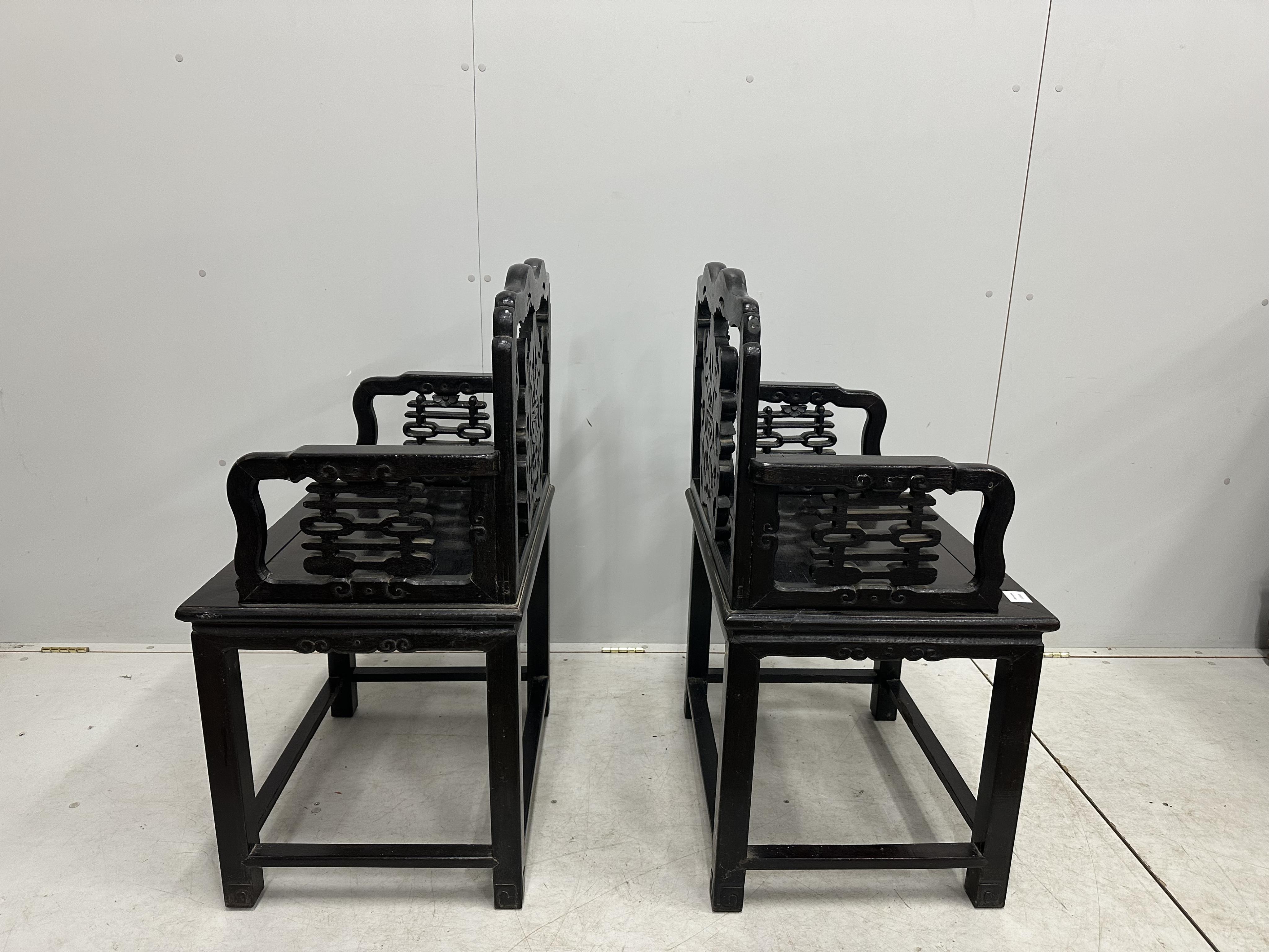 A pair of Chinese hongmu elbow chair, width 64cm, depth 46cm, height 98cm. Condition - fair